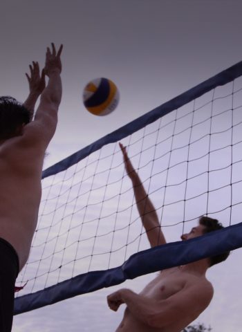 two men playing volleyball