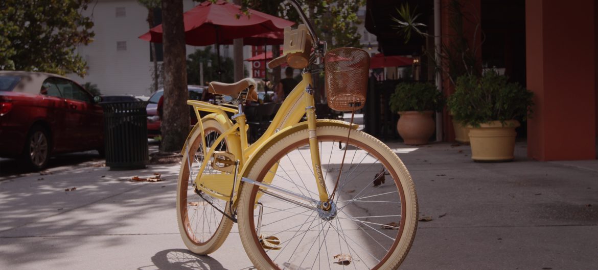 yellow bicycle on sidewalk